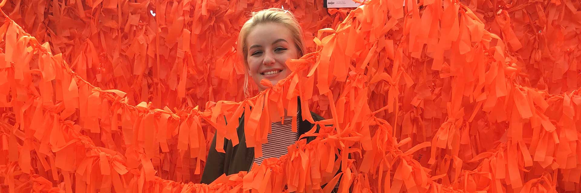 ArtPrize 2016 visitor with the Color Me Orange&mdash;Color Me Kind installation